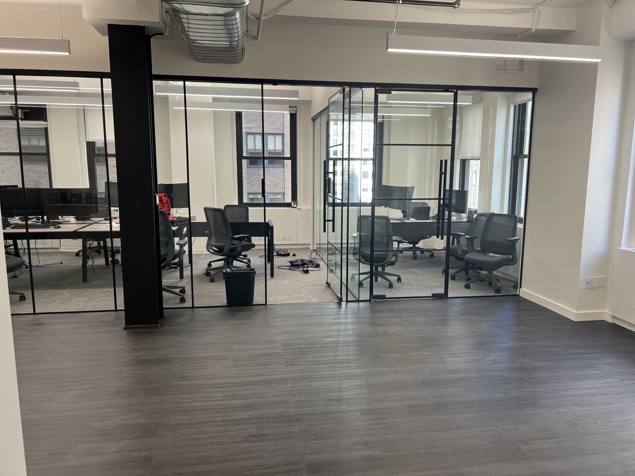 Finished commercial office interior with glass-walled meeting rooms, New York City