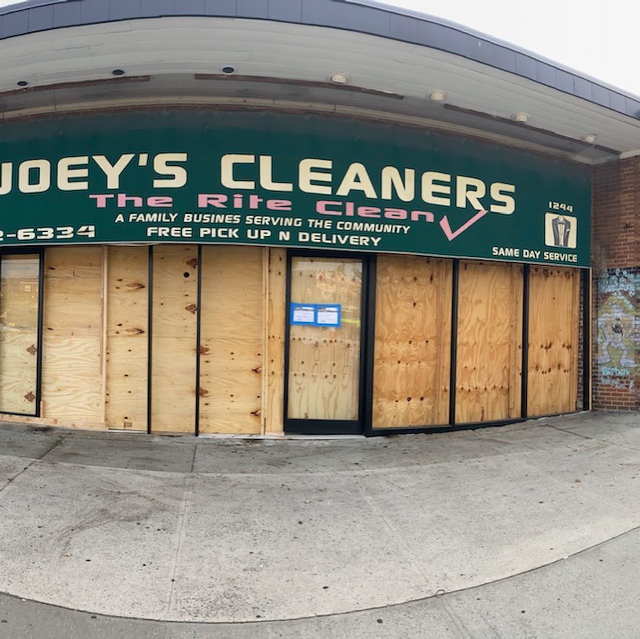 Boarded up retail storefront before renovation, New York City